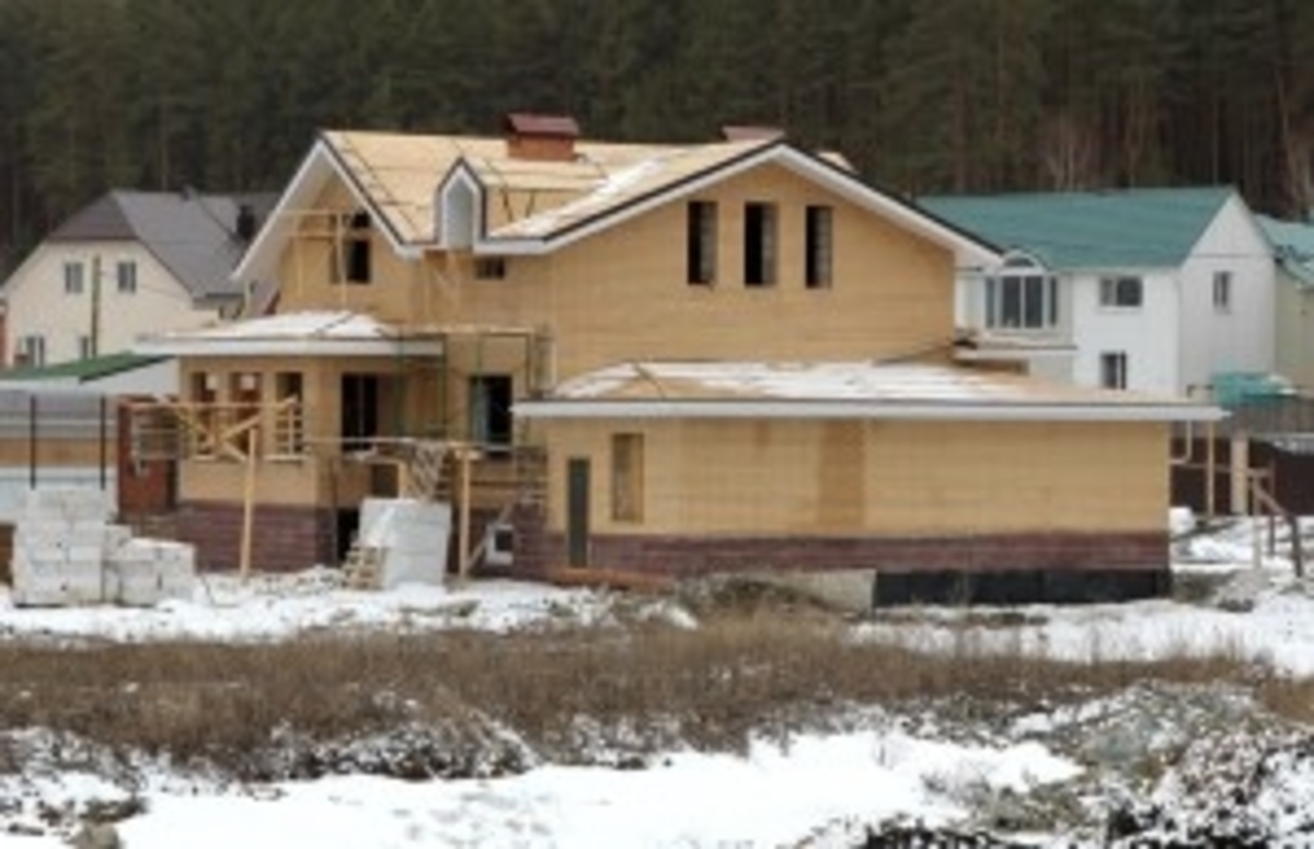 Home in Construction Covered in Snow
