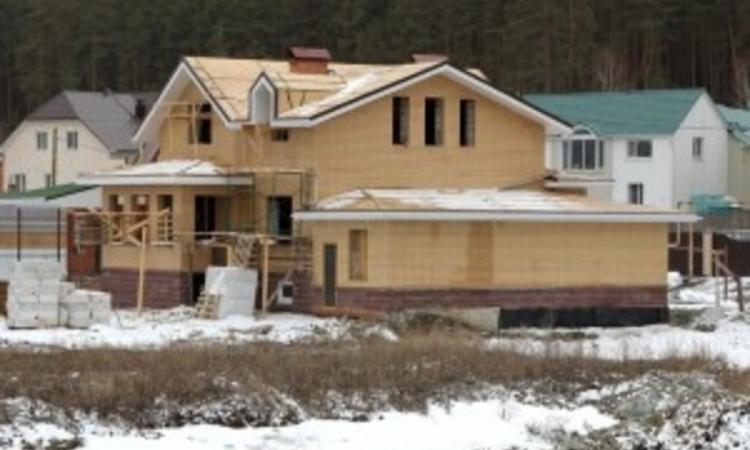 Home in Construction Covered in Snow